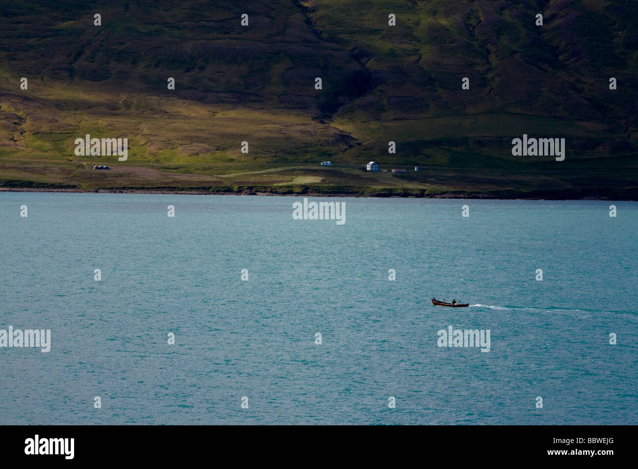Small boat sailing in a fjord Stock Photo - Alamy