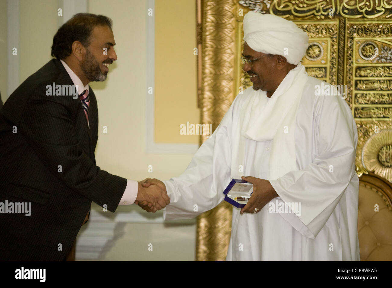 Pakistani-born British Labour peer, Lord Ahmed greets Sudanese President  Omar Hassan Ahmad al-Bashir in Khartoum palace room Stock Photo