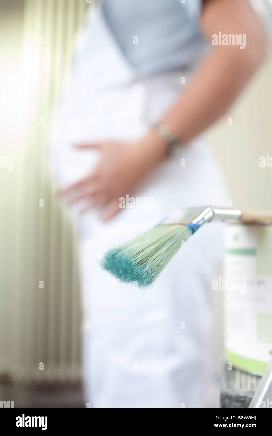 Pregnant woman is painting Stock Photo