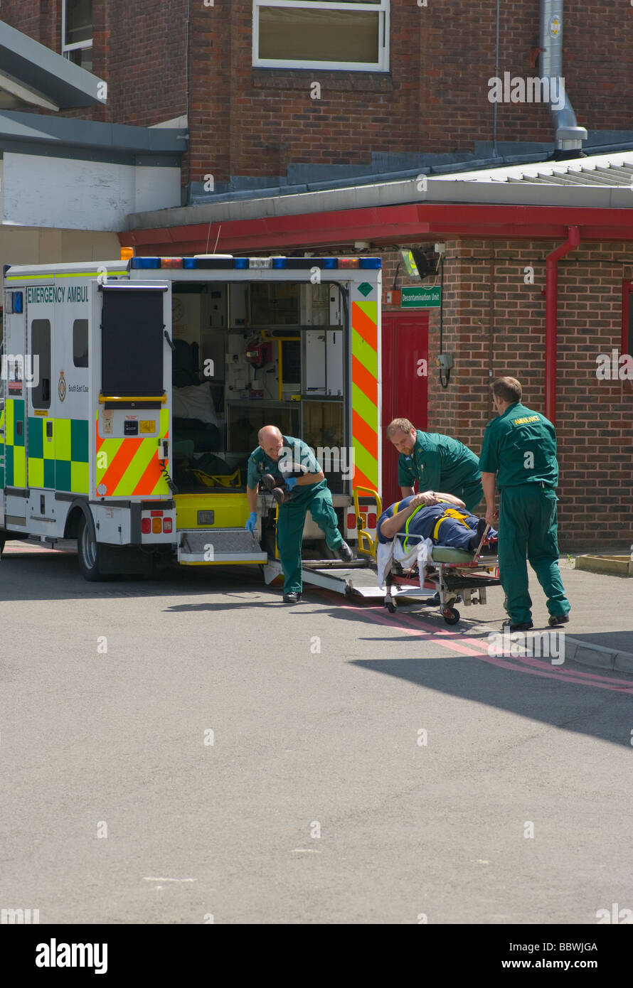 Ambulance Crew Offloading a Patient at The Emergency Department East Surrey NHS Hospital Redhill England Stock Photo