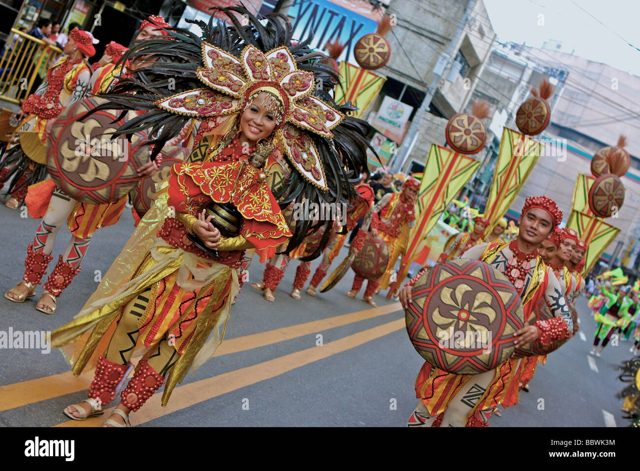 woman with sinulog costume and a Santo Niño doll in the sinulog parade