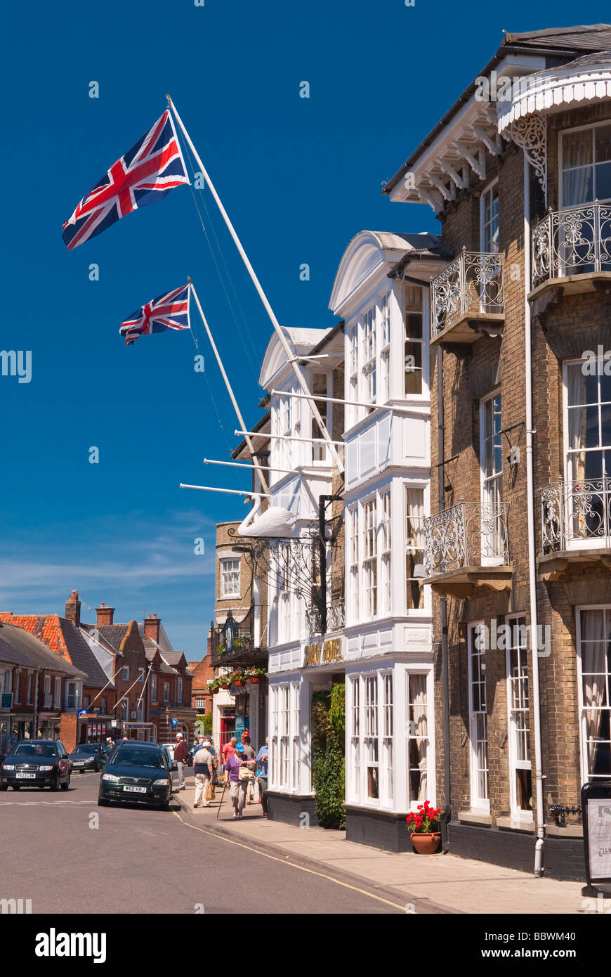 A view of Southwold high street in Suffolk uk with the swan inn hotel in the foreground in the summer with people Stock Photo