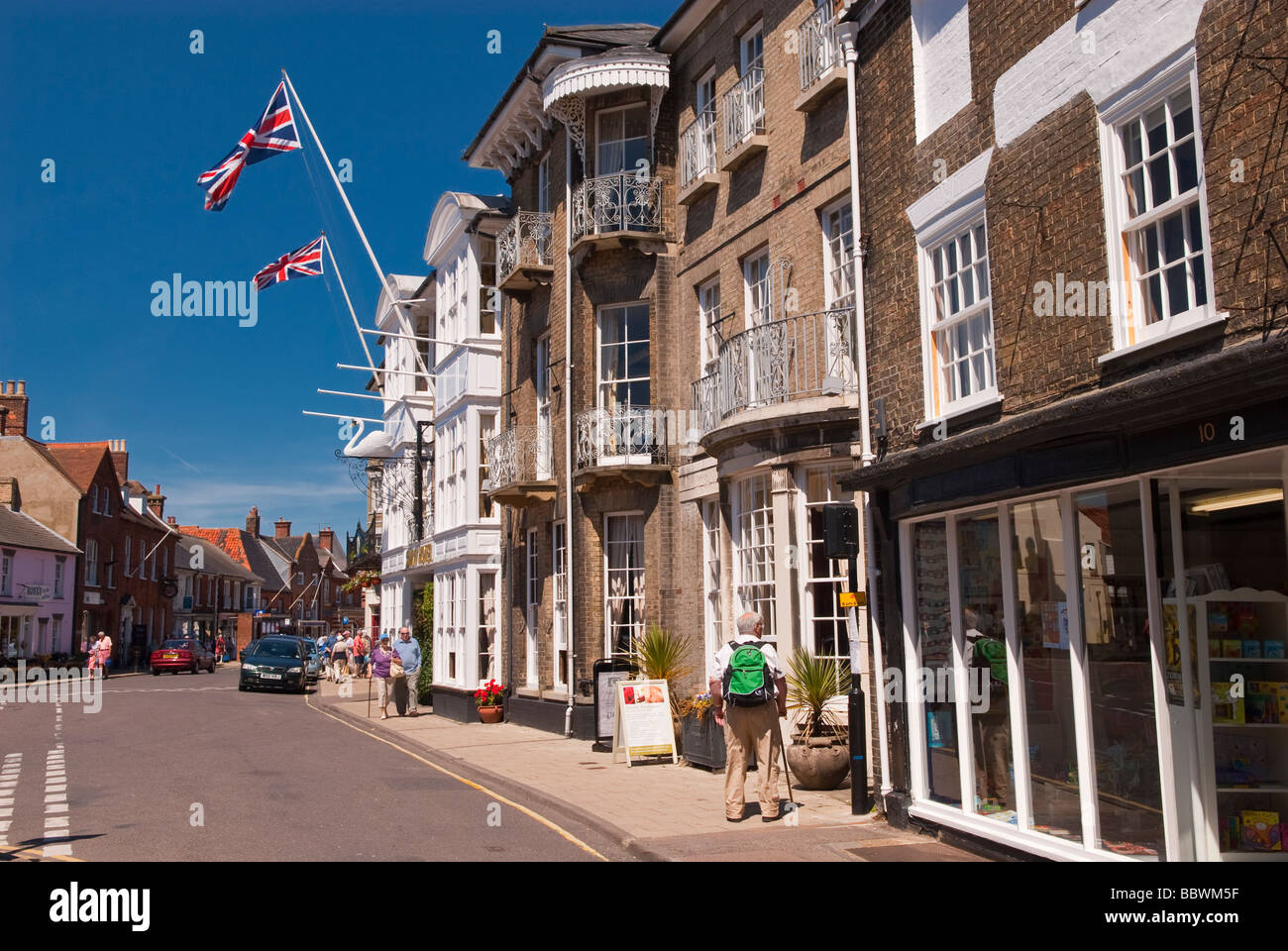 A view of Southwold high street in Suffolk uk with the swan inn hotel in the foreground in the summer with people Stock Photo
