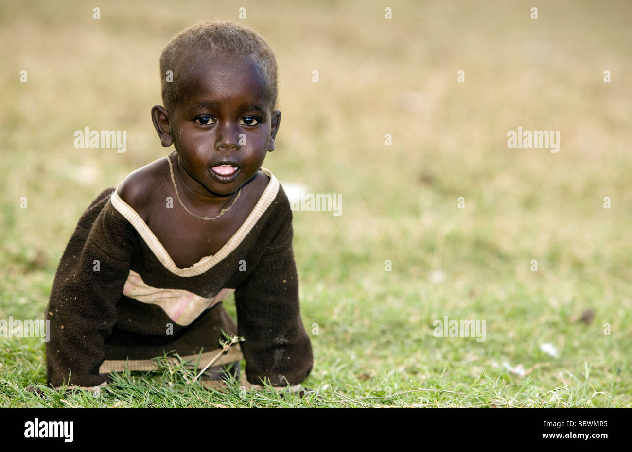 Young Maasai Child - Maasai Village - Maasai Mara National Reserve, Kenya Stock Photo