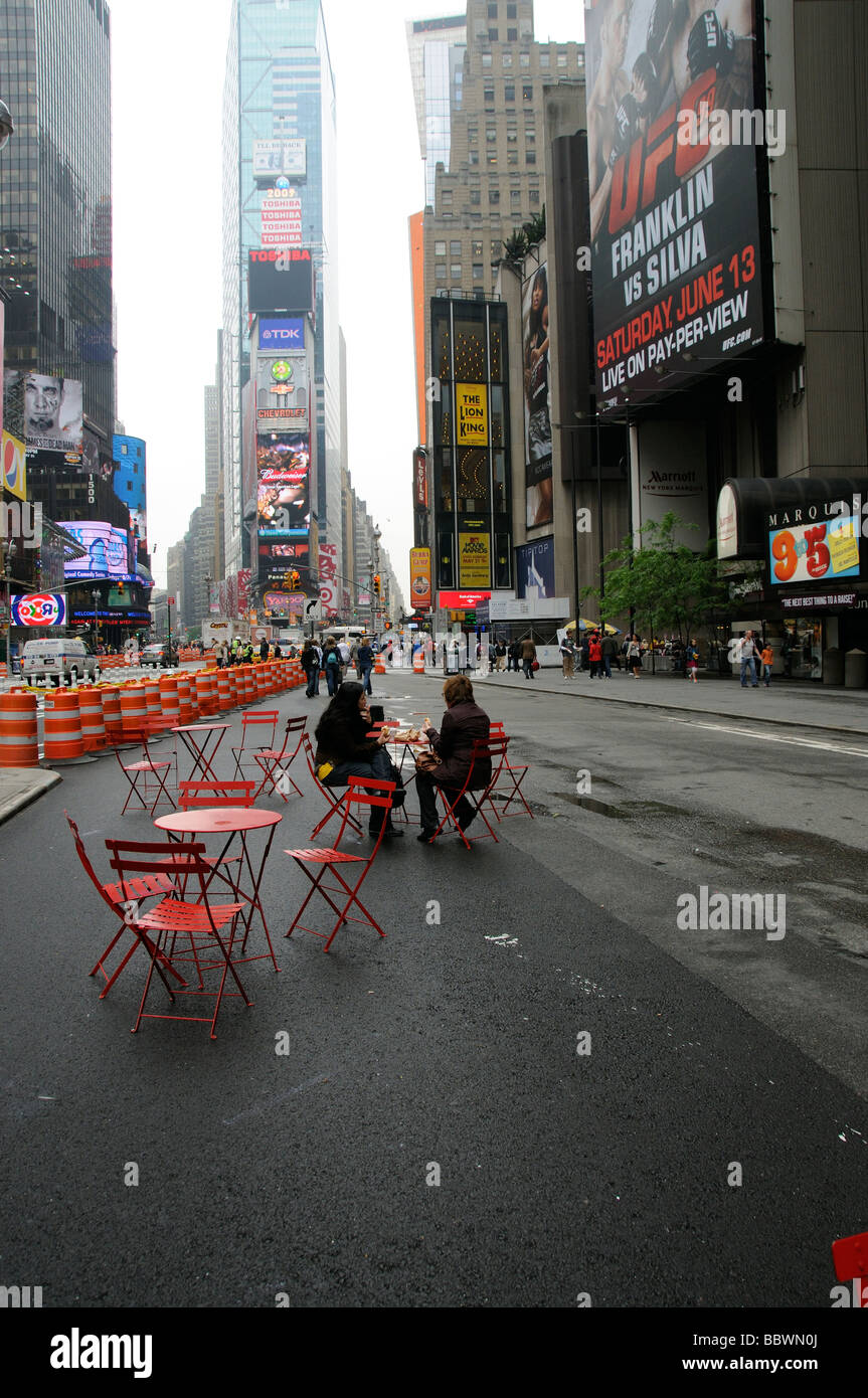 Times Square New York road closure for traffic and residents take to sitting in the street on garden chairs Stock Photo
