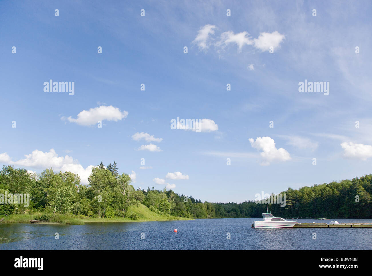 Power boat tied to a dock in the Union River Ellsworth Maine Stock
