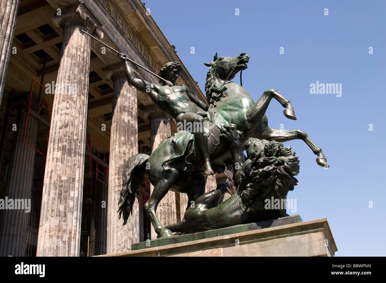 Statue of Amazon on horseback fighting a Lion sculpture in front of