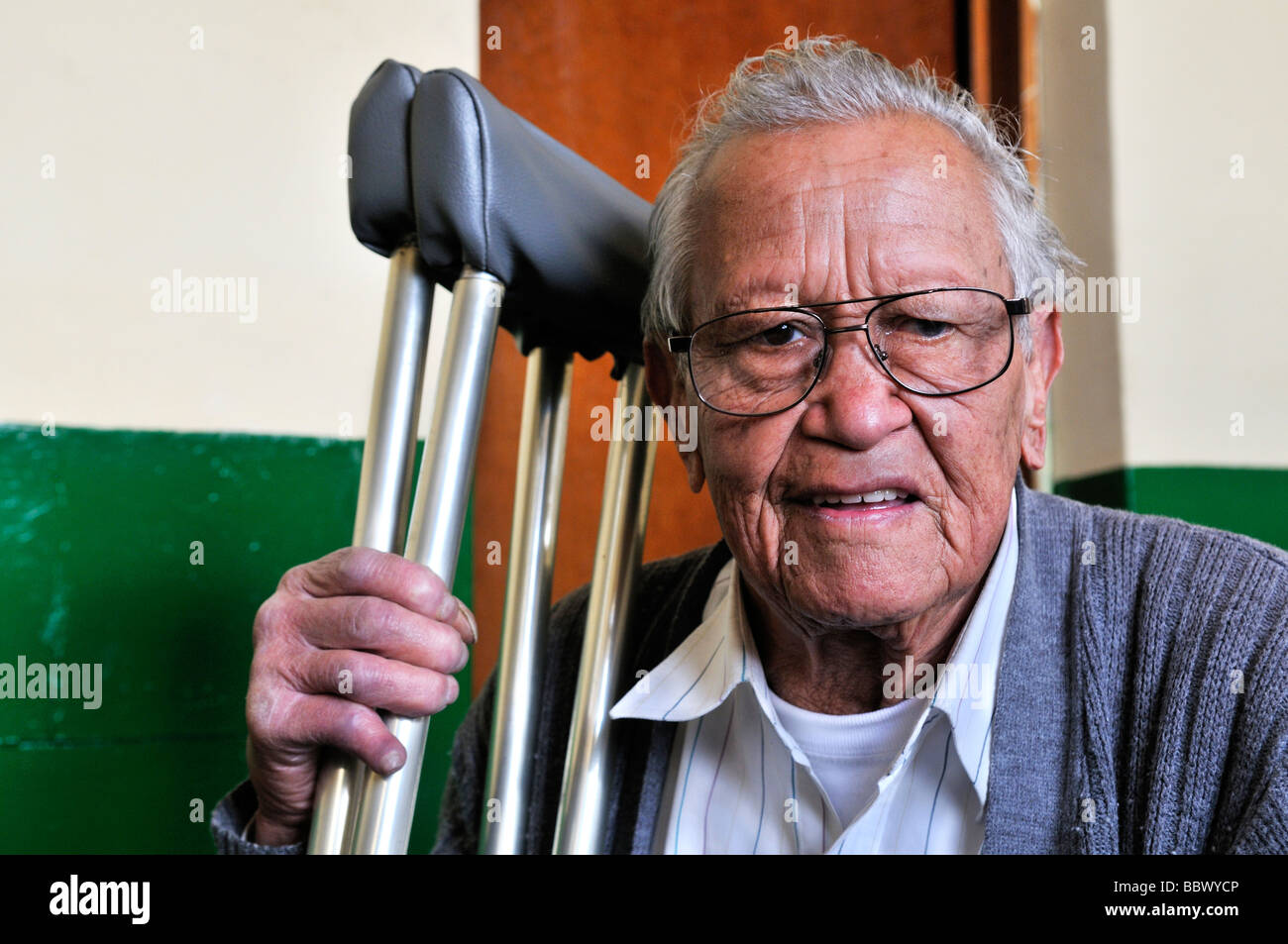 Leprosy patient with crutches, 77 years, in the ASOHAN, a self-help organization for leprosy sufferers, Bogota, Colombia, South Stock Photo