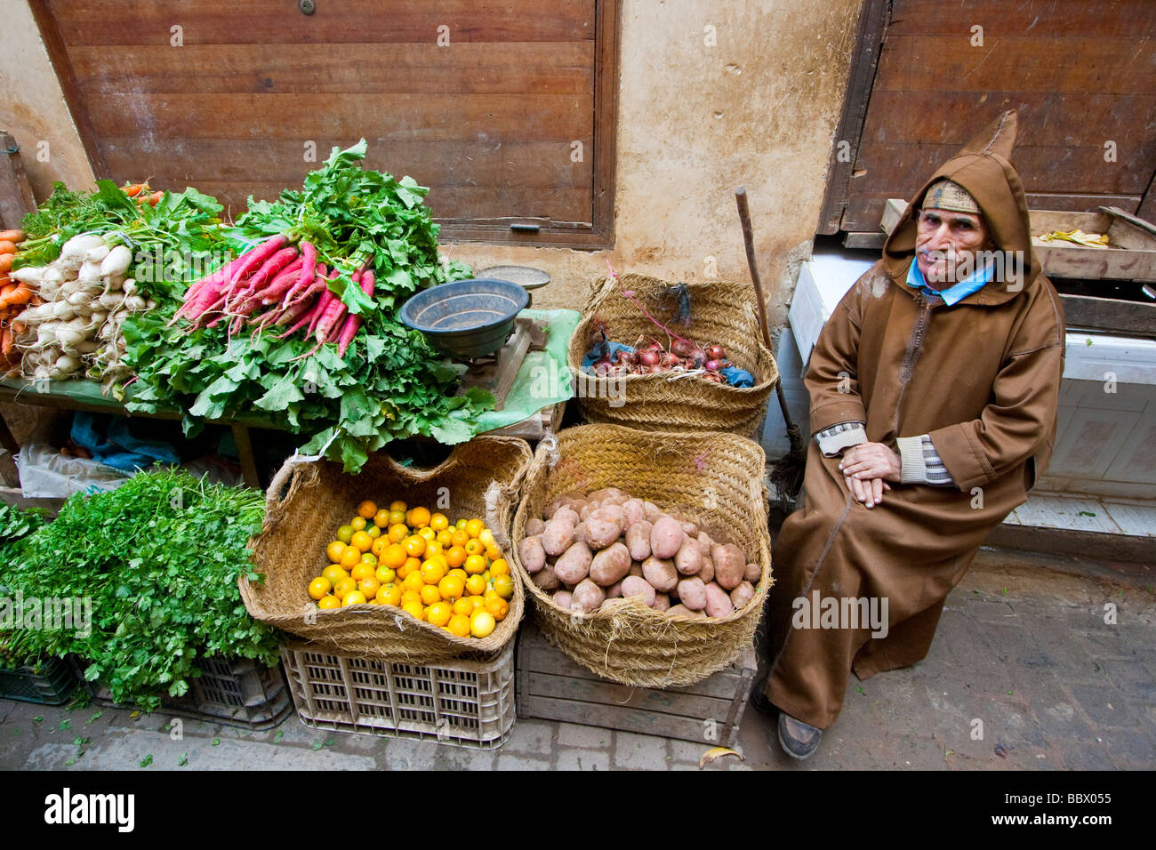 Morroccan Vegetable Vendor Wearing Hoodie in Fez Morrocco Stock Photo
