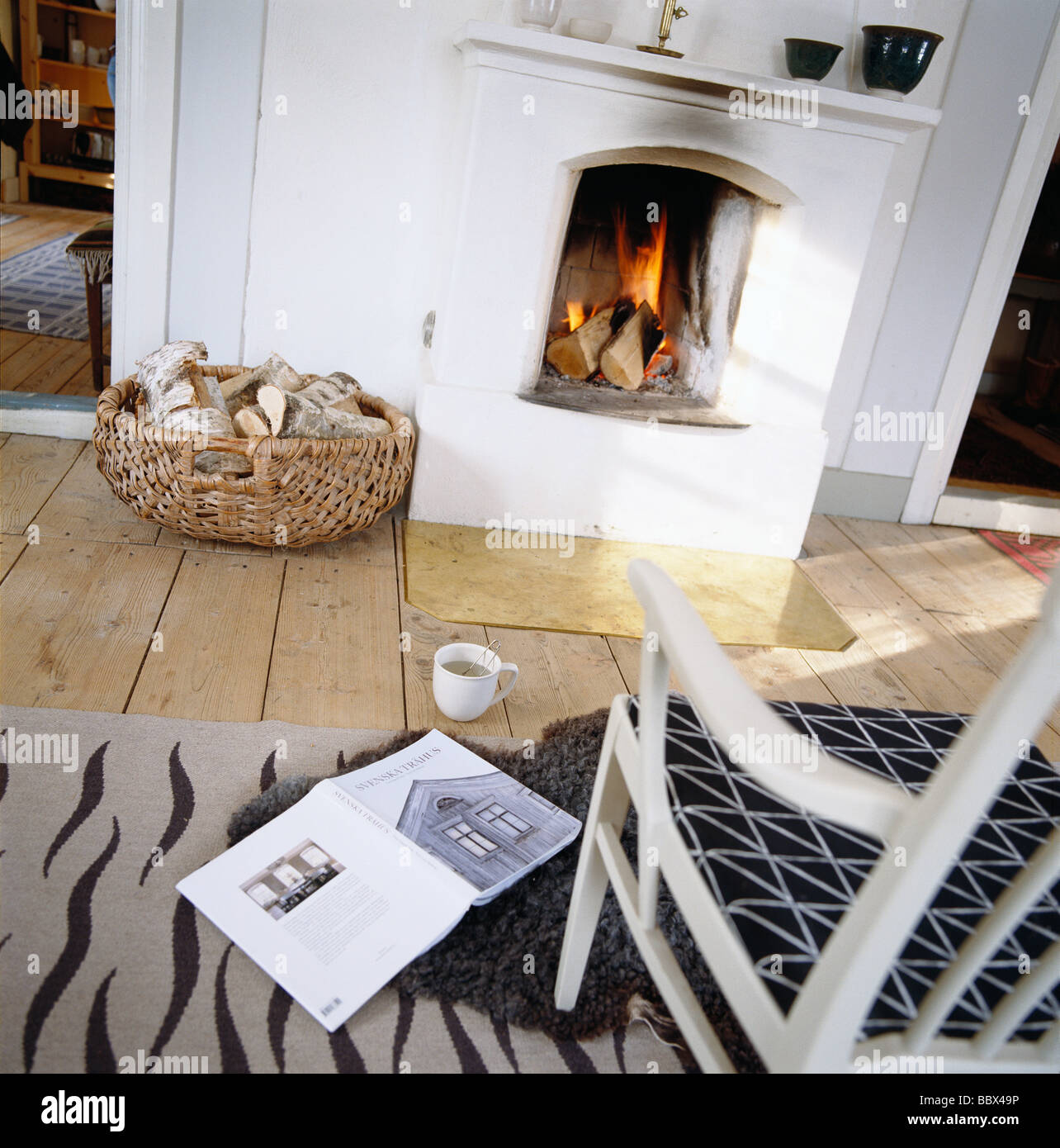 An armchair in front of a fireplace Sweden Stock Photo Alamy