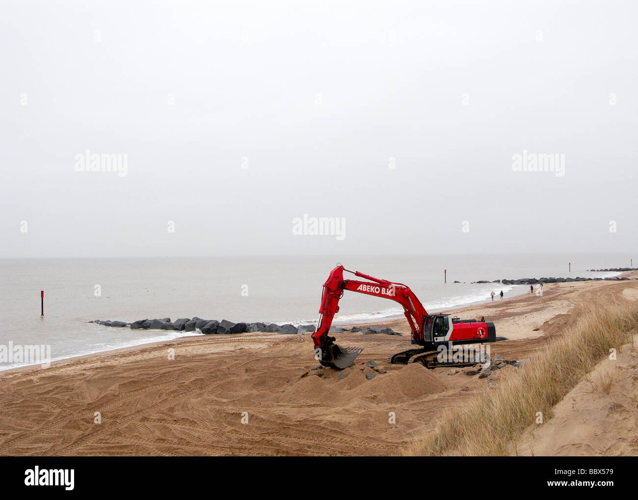 digger repairing norfolk sea defences Stock Photo