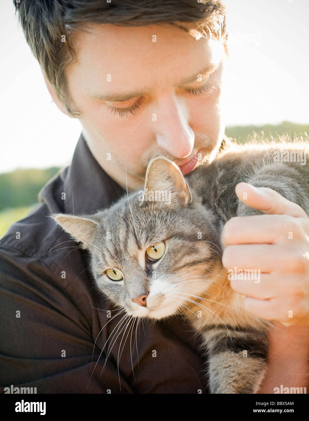 A young man holding a cat Sweden. Stock Photo