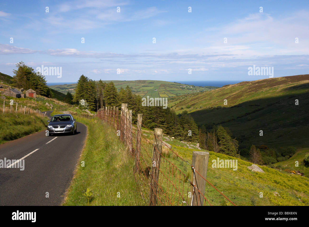 car driving along country mountain road through glenaan scenic route glenaan county antrim northern ireland uk Stock Photo