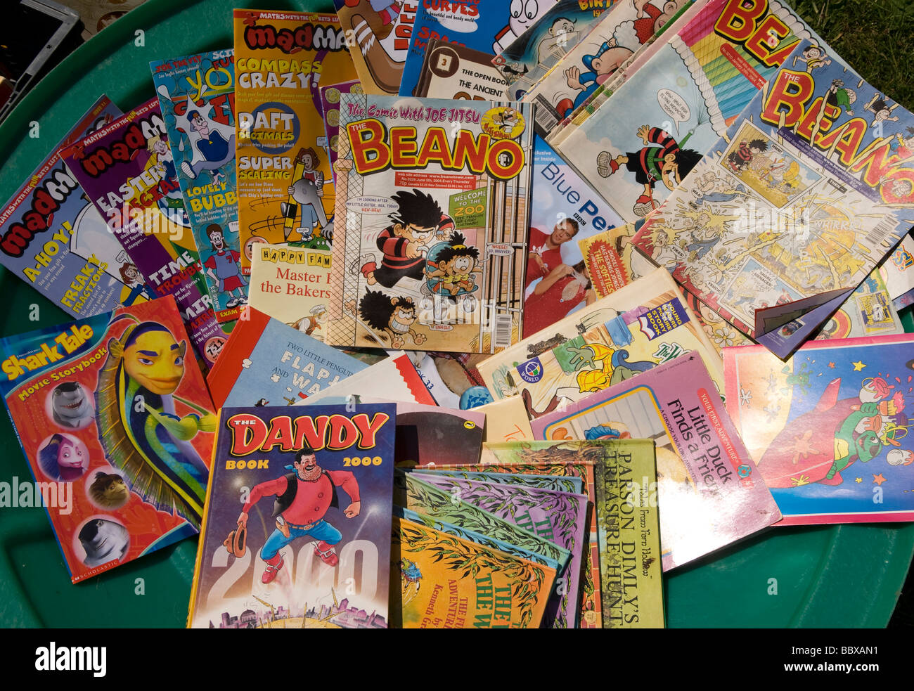 Display of traditional comics on sale at a school summer fete, Medstead, Alton, Hampshire, UK. Stock Photo