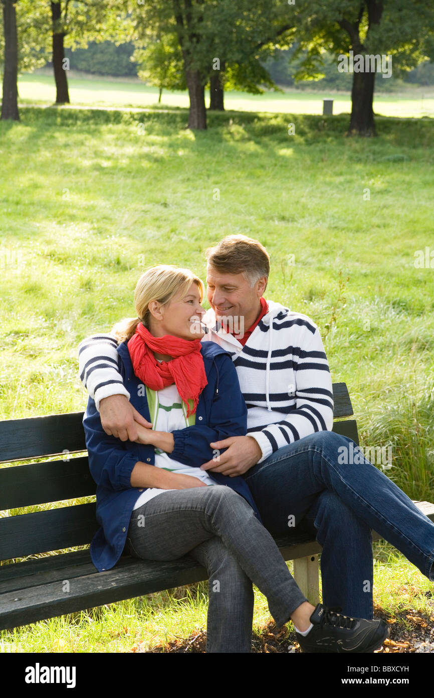 A couple sitting on a bench in the park Sweden Stock Photo - Alamy