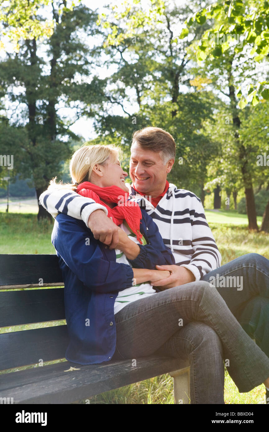 A couple sitting on a bench in the park Sweden Stock Photo - Alamy