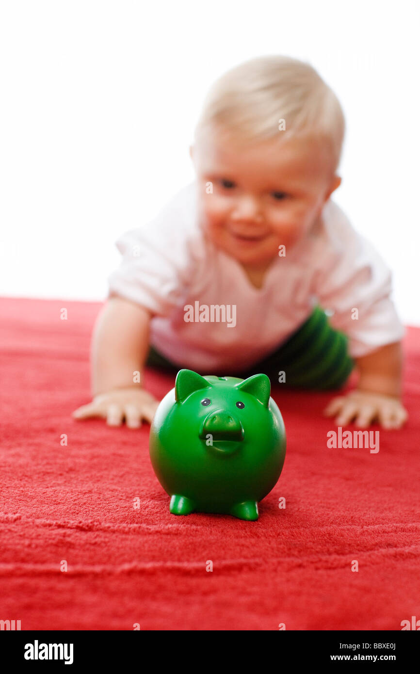 A baby with a piggy bank Stock Photo Alamy