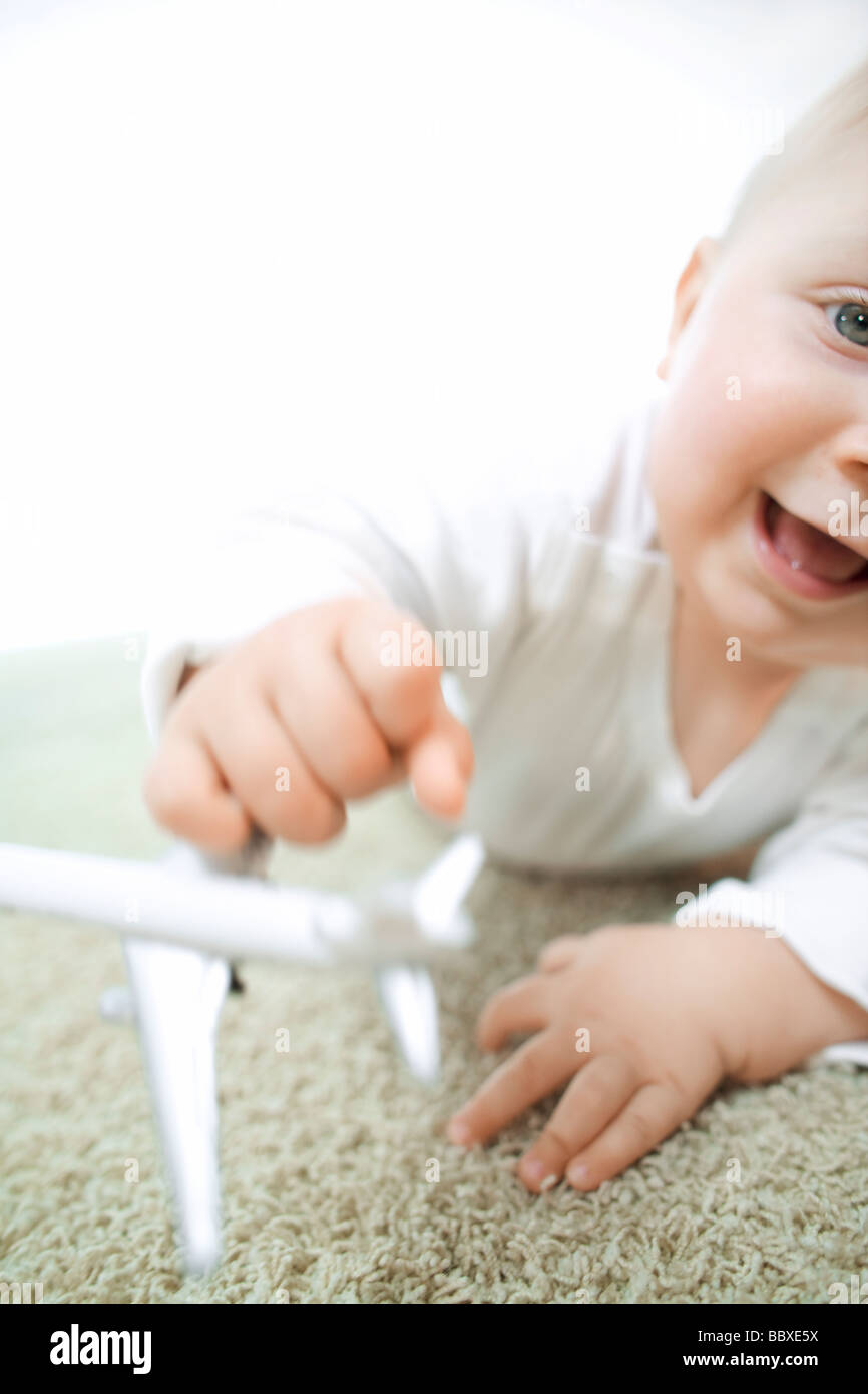 A child playing with a toy aeroplane. Stock Photo