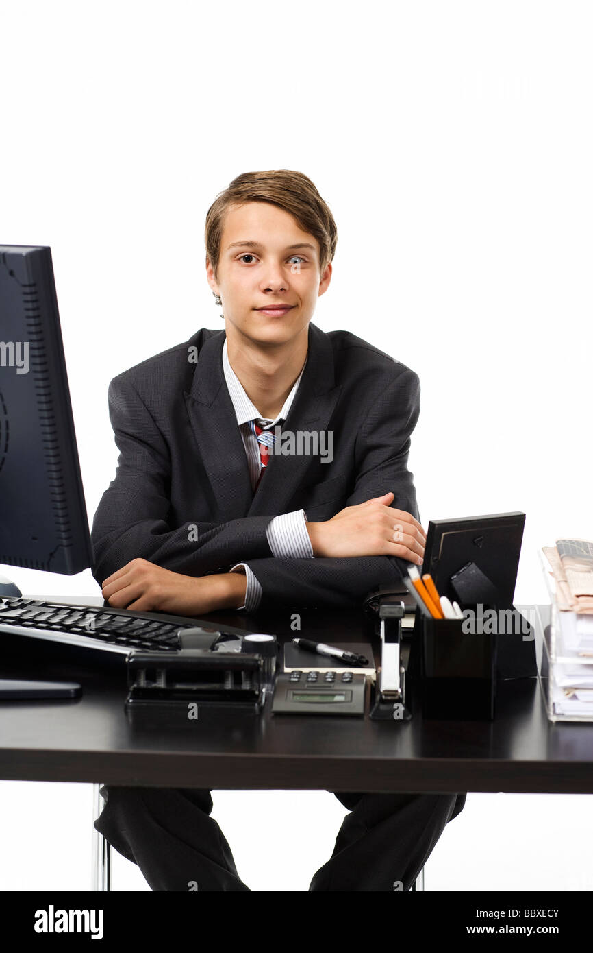 A young boy as a businessman at the office Stock Photo Alamy