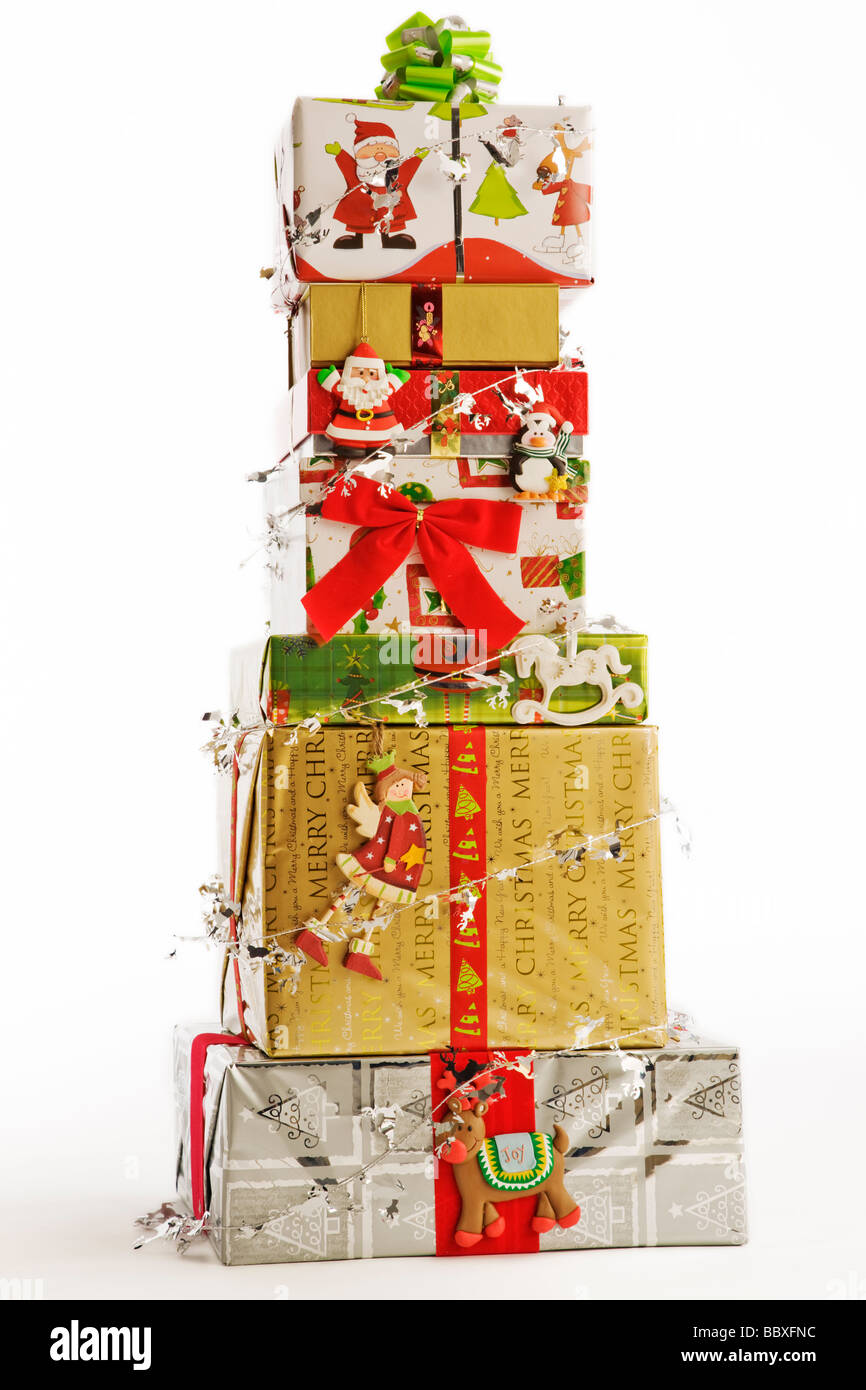 Stack of Christmas gifts against white background Stock Photo