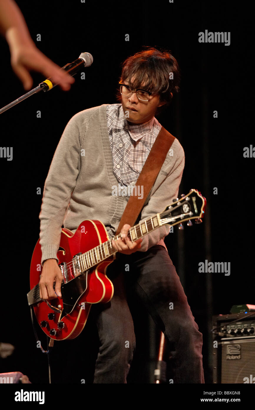 Playing guitar stage. Indonesian Jazz band Mocca and their lead guitarist performing on stage at the Hua Hin jazz festival 2009 Thailand S.E. Asia Stock Photo