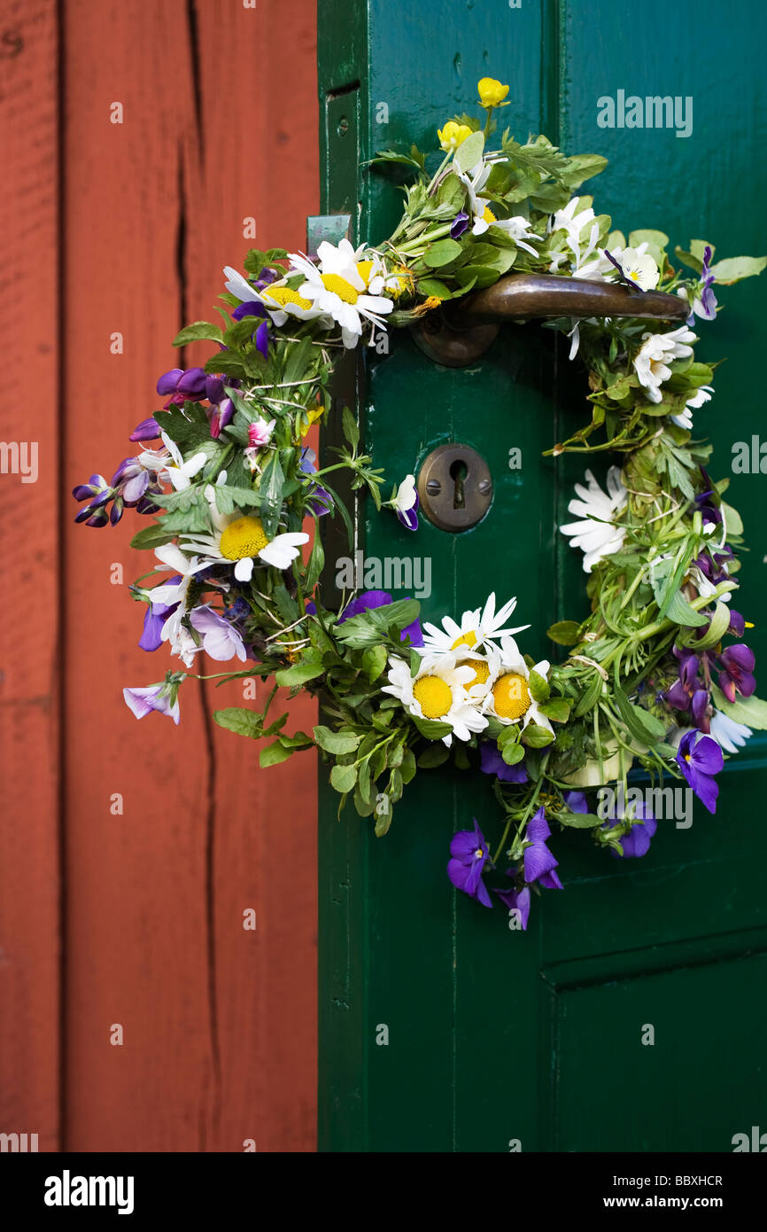 Wreath of flowers in midsummer on a doorhandle Sweden Stock Photo Alamy