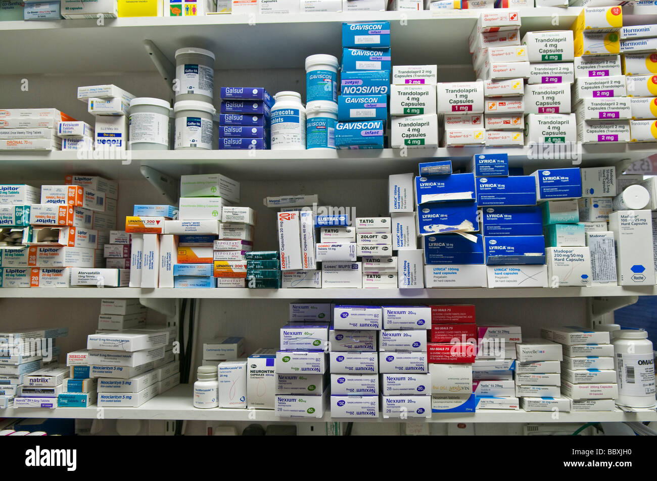 Boxes of drugs piled on a pharmacists shelf Stock Photo
