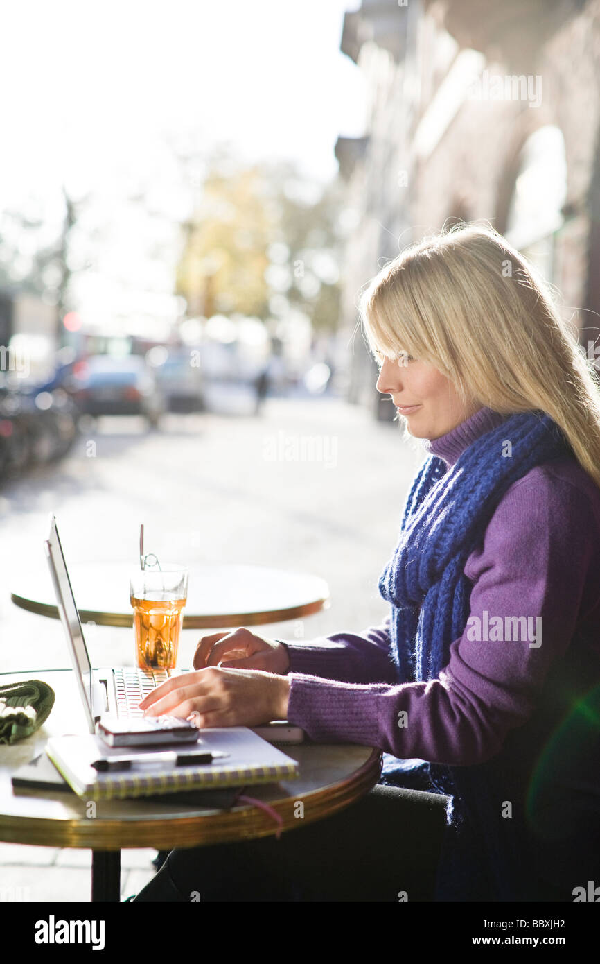 Young woman sitting in a caf using a laptop Sweden. Stock Photo