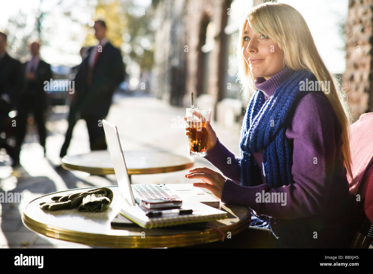 Young woman sitting in a caf using a laptop Sweden. Stock Photo