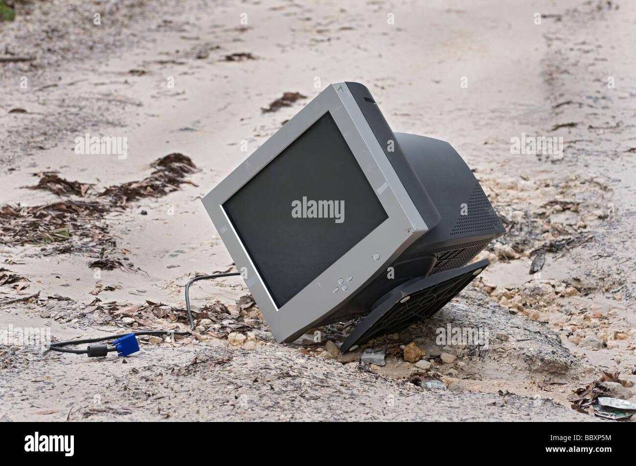 old outdated CRT computer monitor thrown away with the garbage at roadside Stock Photo