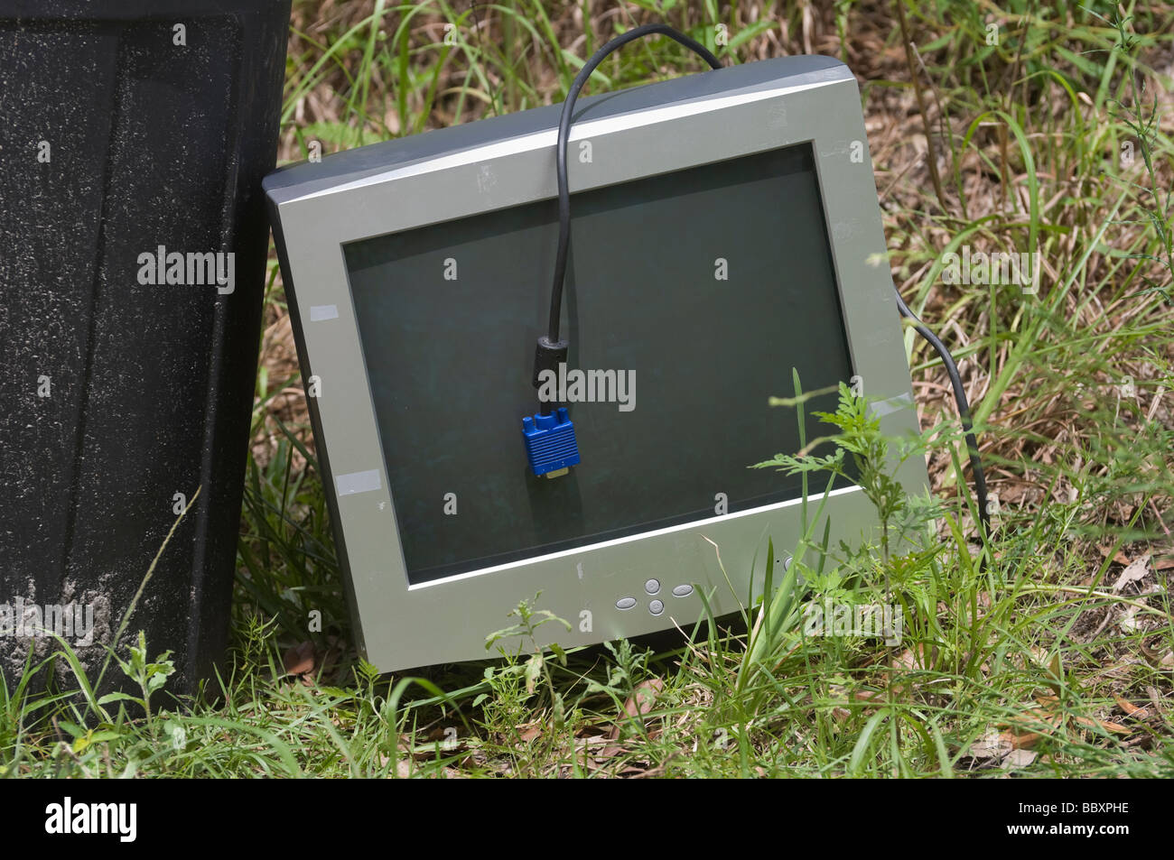 old outdated CRT computer monitor thrown away with the garbage at roadside Stock Photo