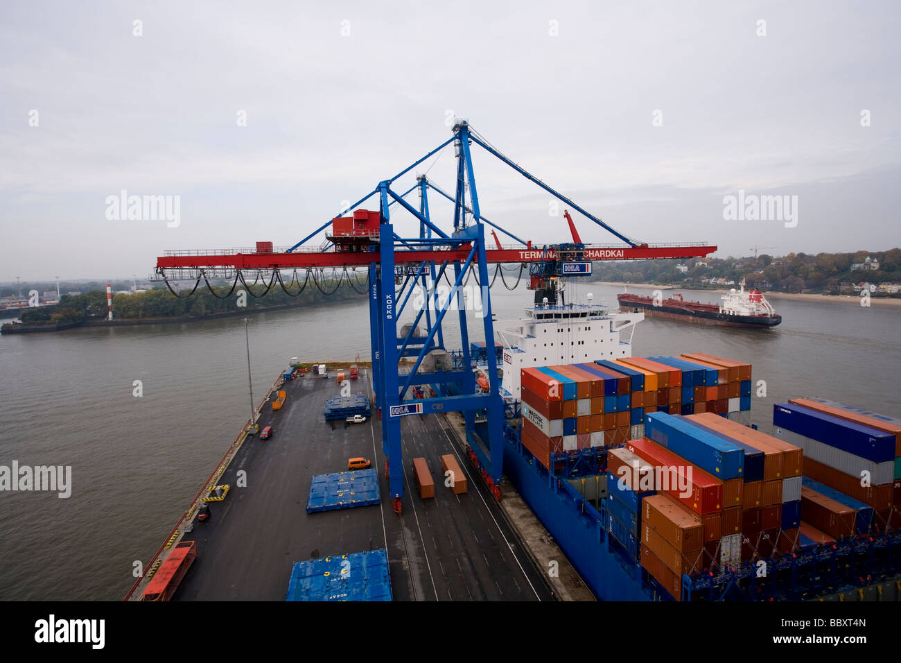 A high view of Post-Panamax cranes unloading containers at a European port. Stock Photo