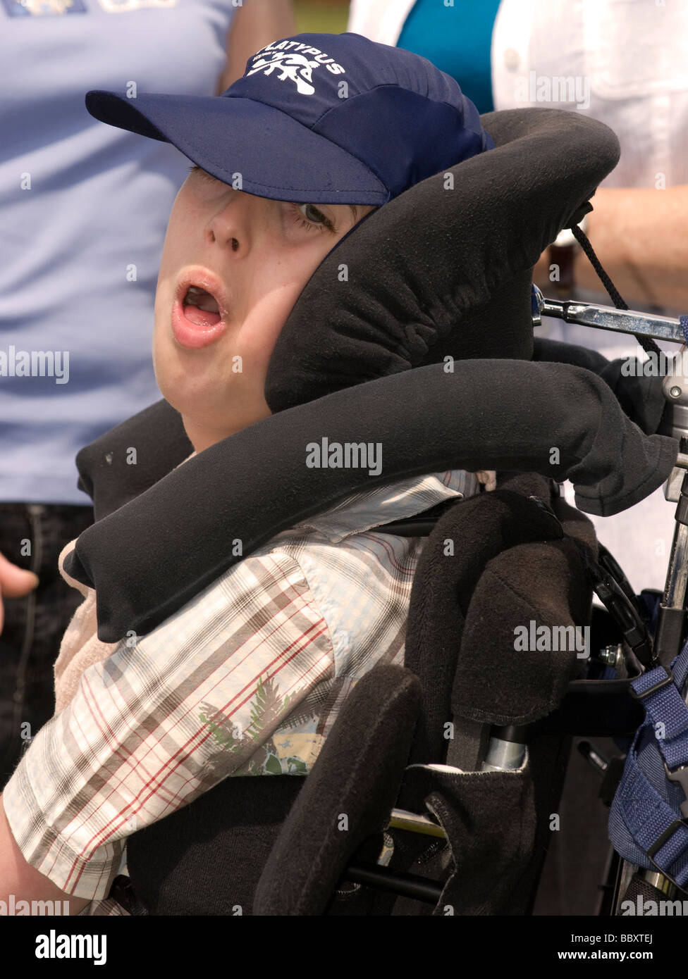 Disabled boy in wheelchair with protective surround, Alton, Hampshire, UK. Stock Photo