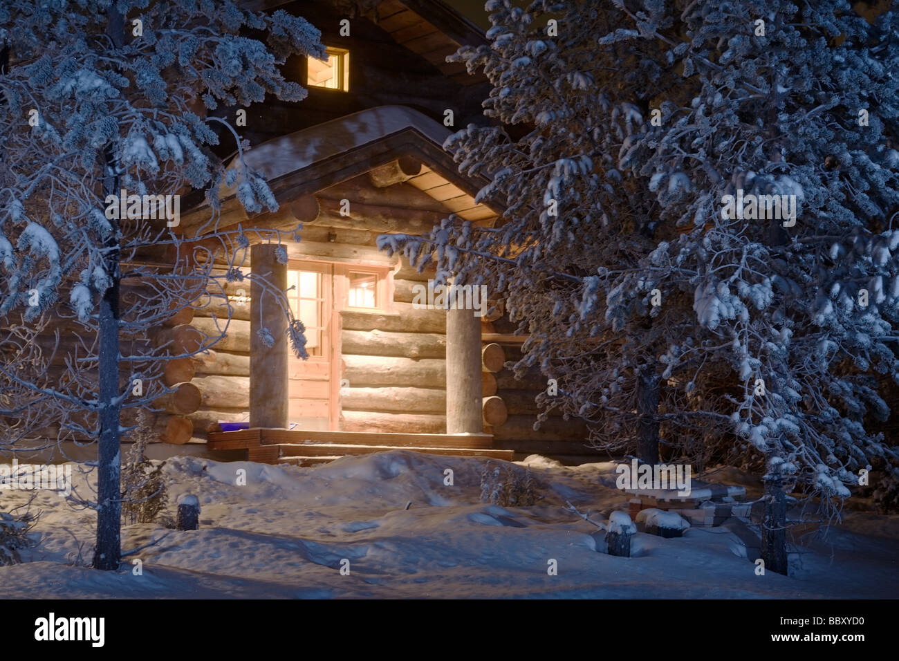 cozy wooden cottage in dark winter forest Stock Photo - Alamy