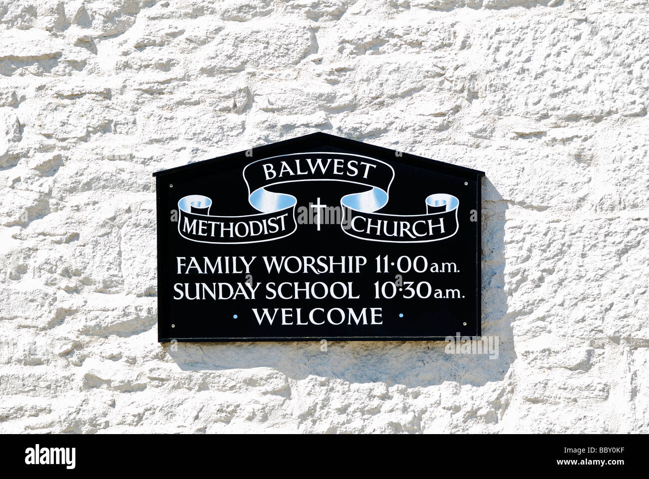 a wall plaque of worship times at a methodist church in cornwall, uk Stock Photo