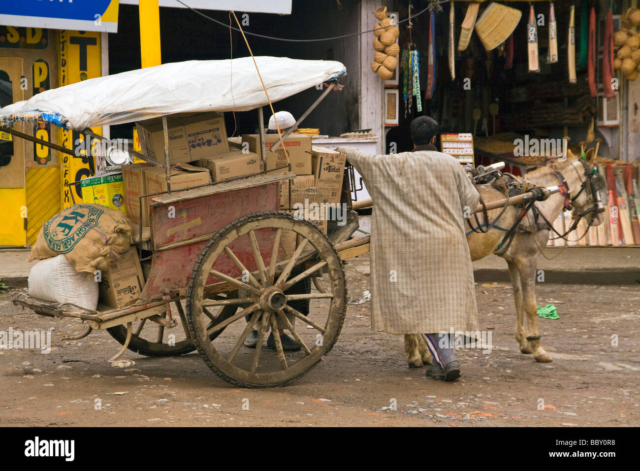 Traditional trader sells his wares from a horse and cart Stock Photo