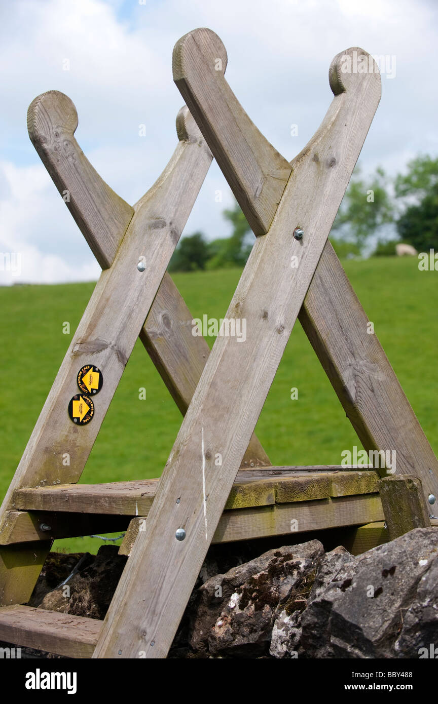 Wooden stile over drystone wall on public footpath in Peak District
