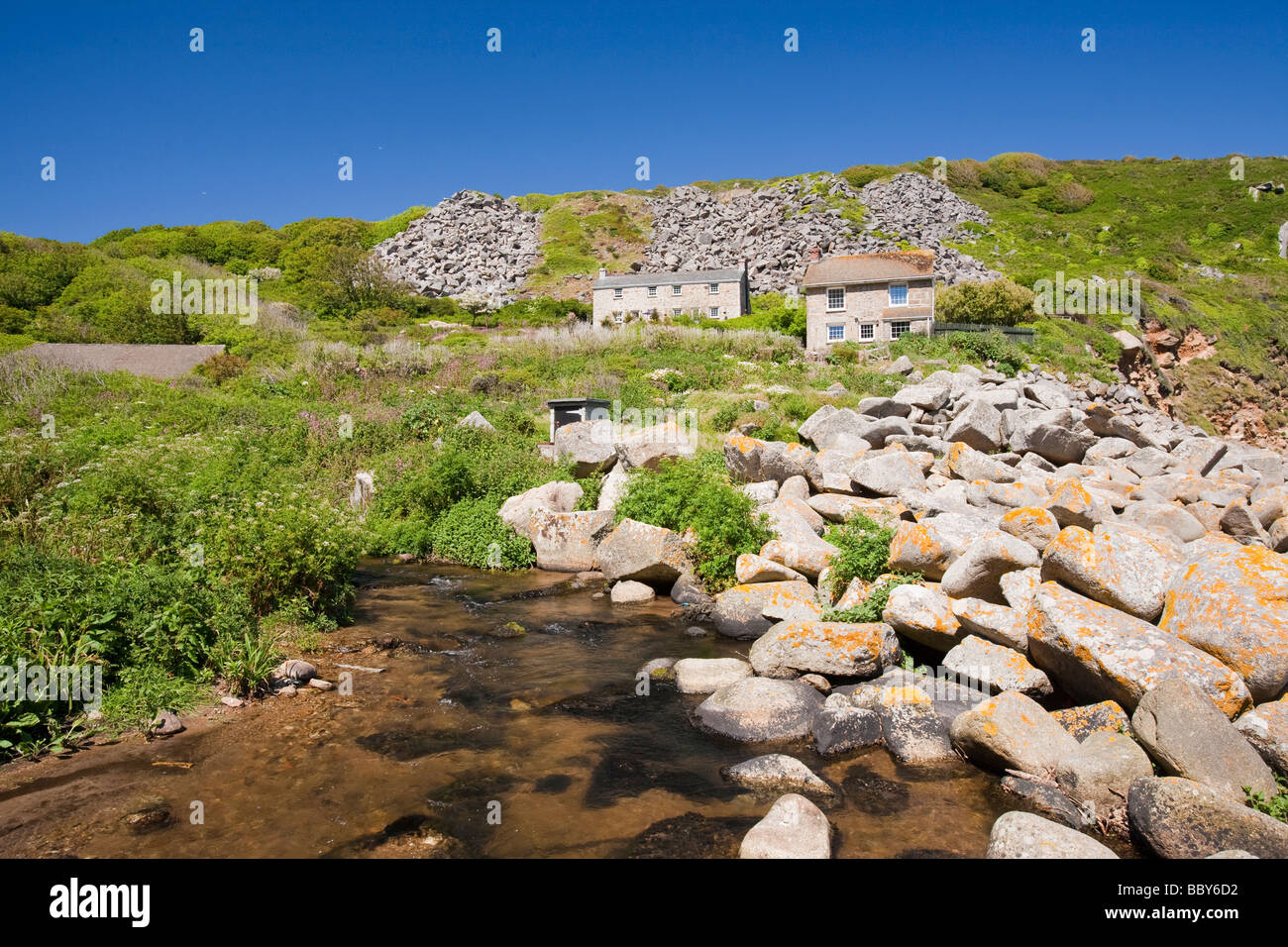 houses at Lamorna cove in Cornwall UK overshadowed by boulders from an