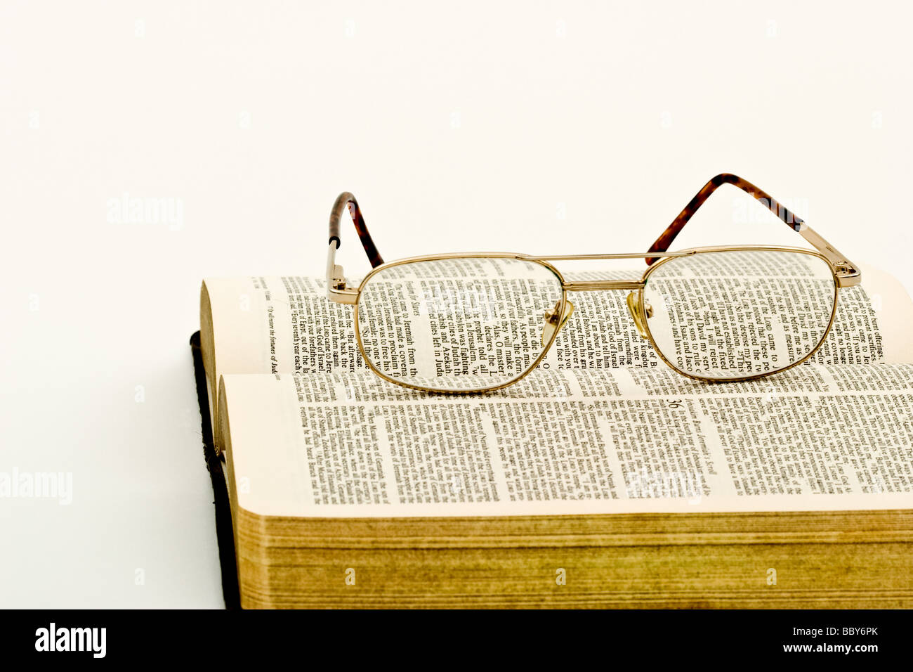 Reading glasses on top of an open book Stock Photo Alamy