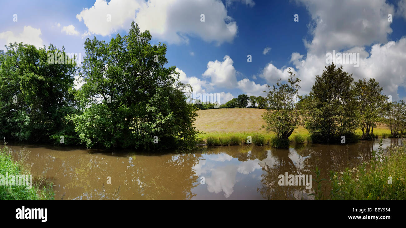 The banks of a river with bushes and trees Stock Photo - Alamy