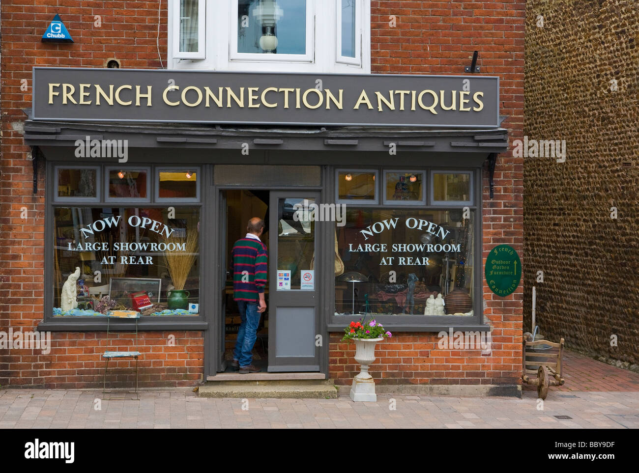 English shop selling French antiques with a slightly wobbly shop sign UK Stock Photo