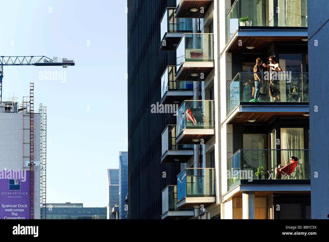 Young people in new apartment blocks in the dockland area of central Dublin Republic of Ireland Stock Photo