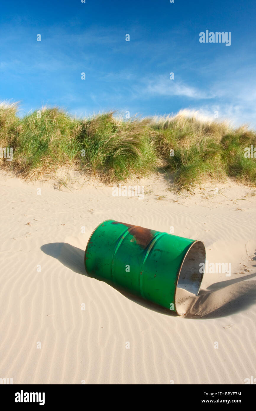 An abandoned oil drum lays washed up on the sand on the Dunes between