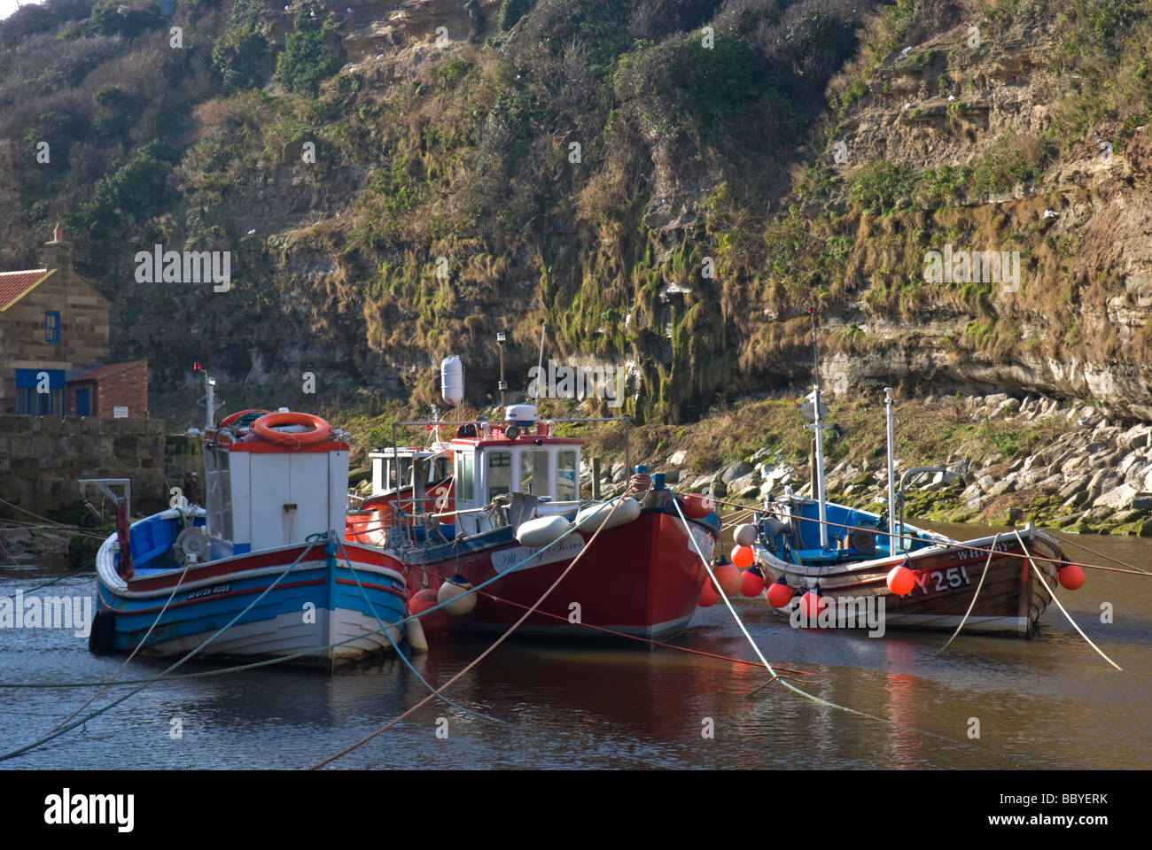 Fishing boats in the harbour at Staithes Yorkshire England Stock Photo