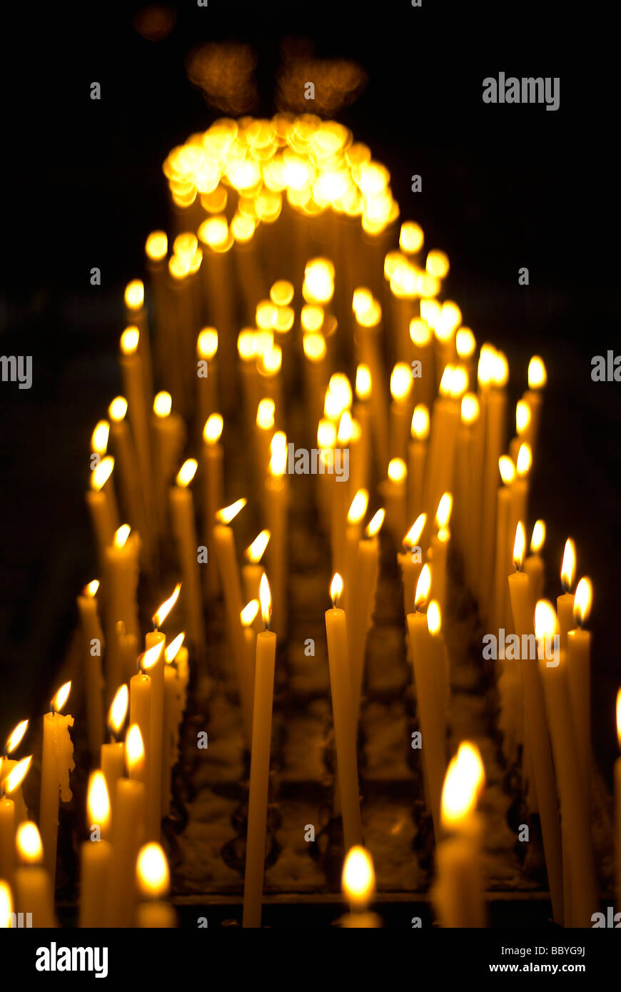 Votive candles burning in a church Stock Photo Alamy