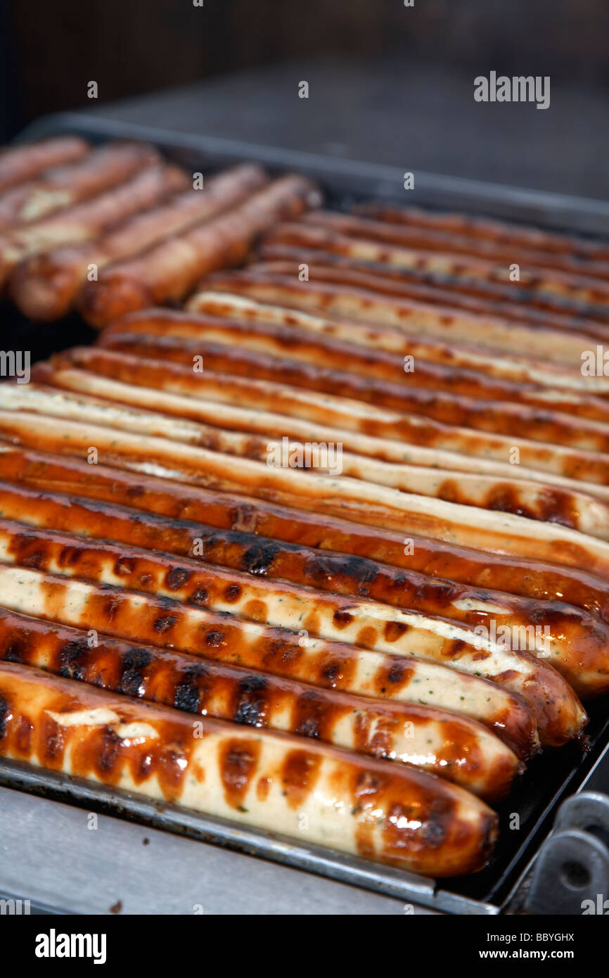 german sausages on grill on sale at an outdoor market in the uk Stock Photo