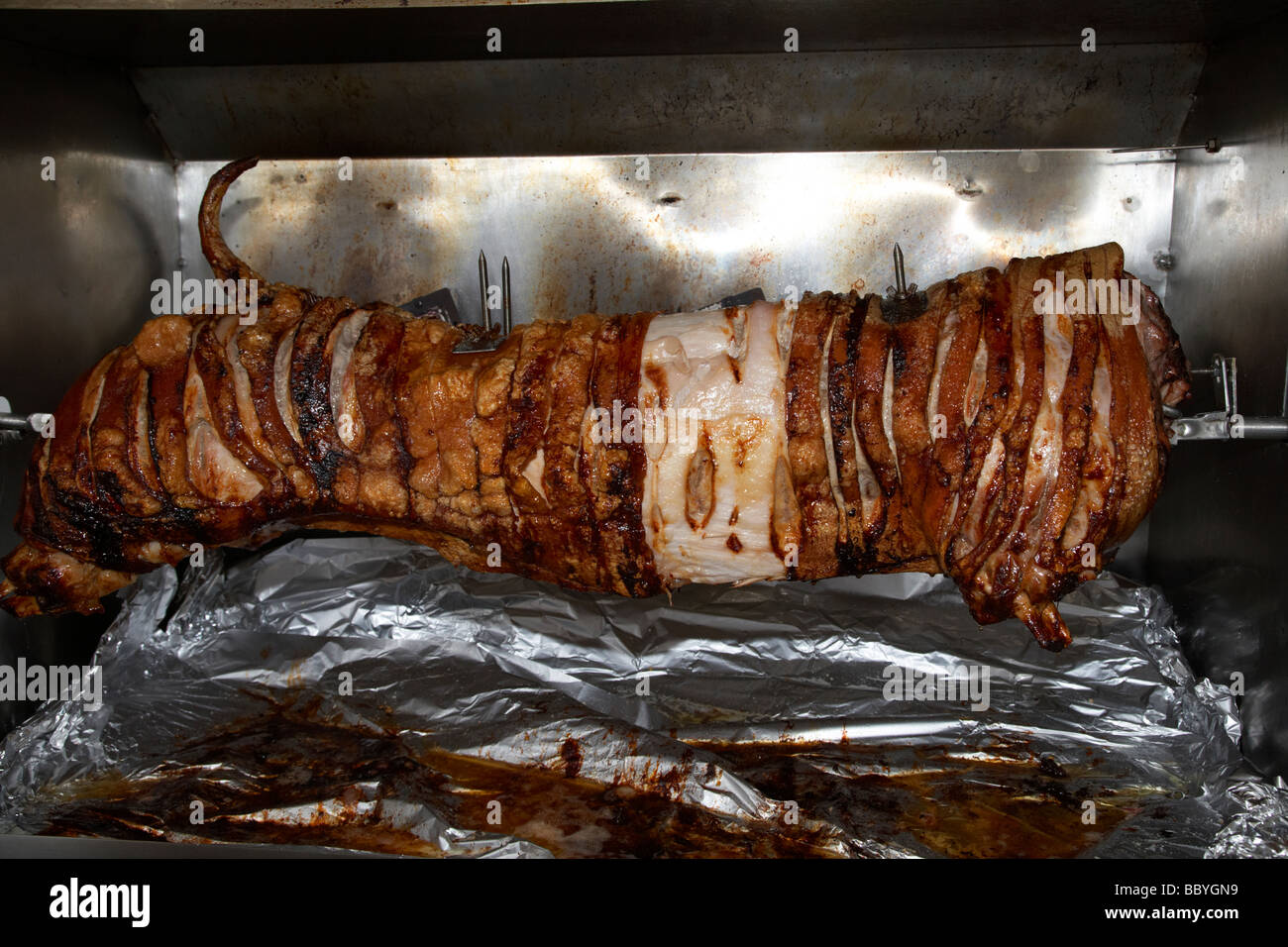 commercial hog roast oven with pig roasting at an event in the uk Stock Photo