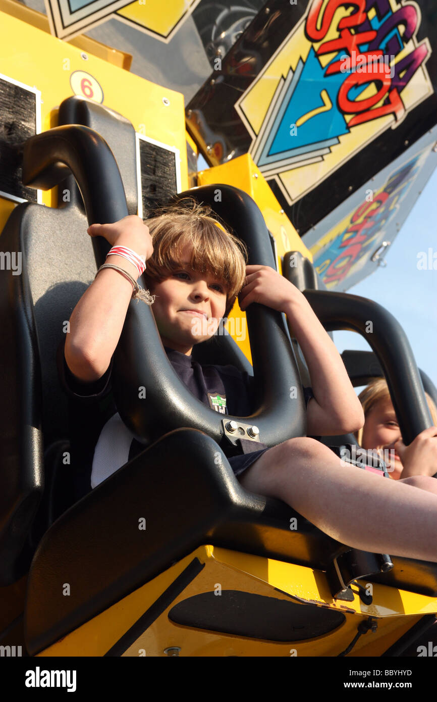 Boy getting harnessed on amusement ride Stock Photo