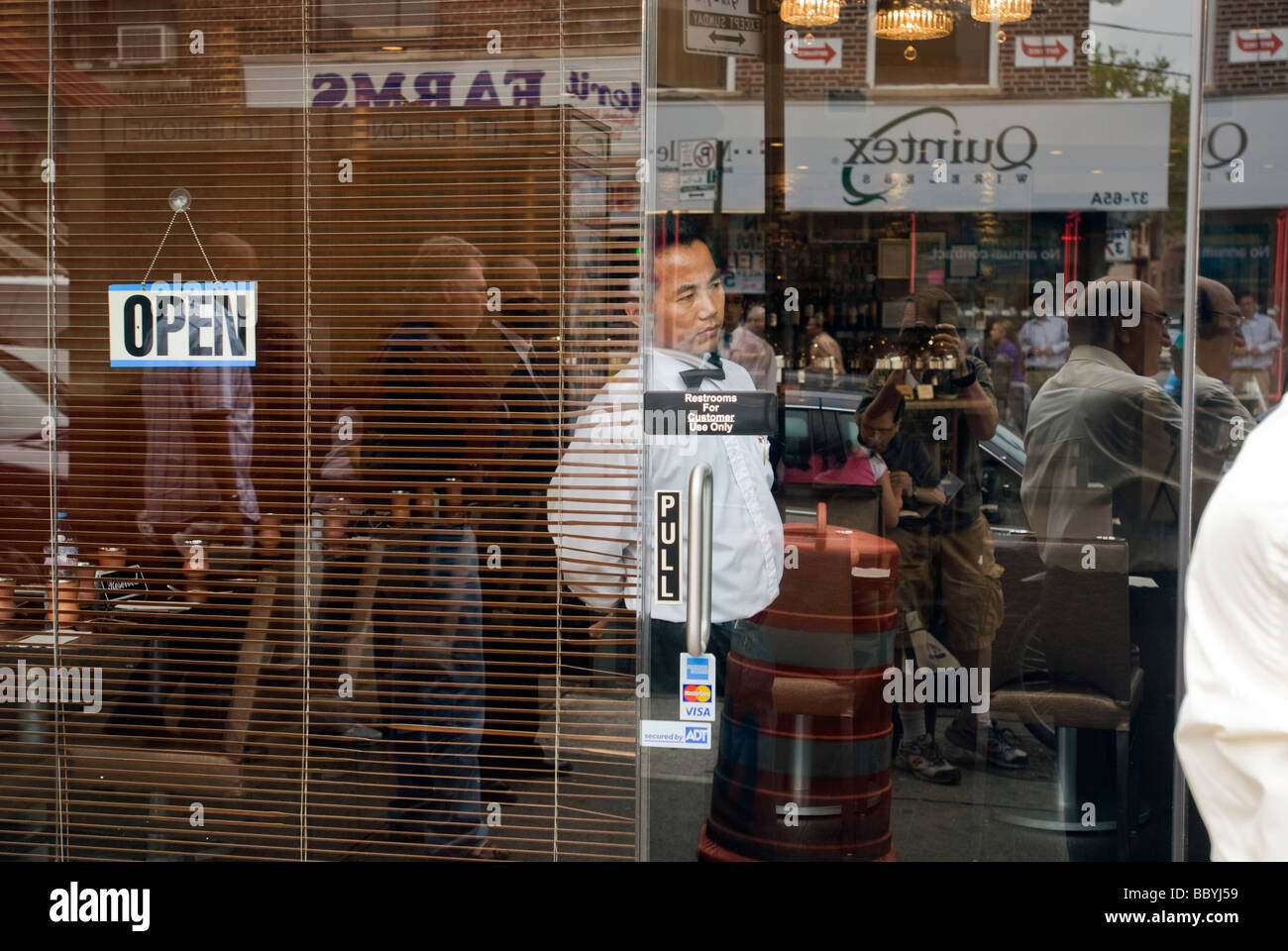 Waiter Waits At The Door Of The Delhi Heights Restaurant In The