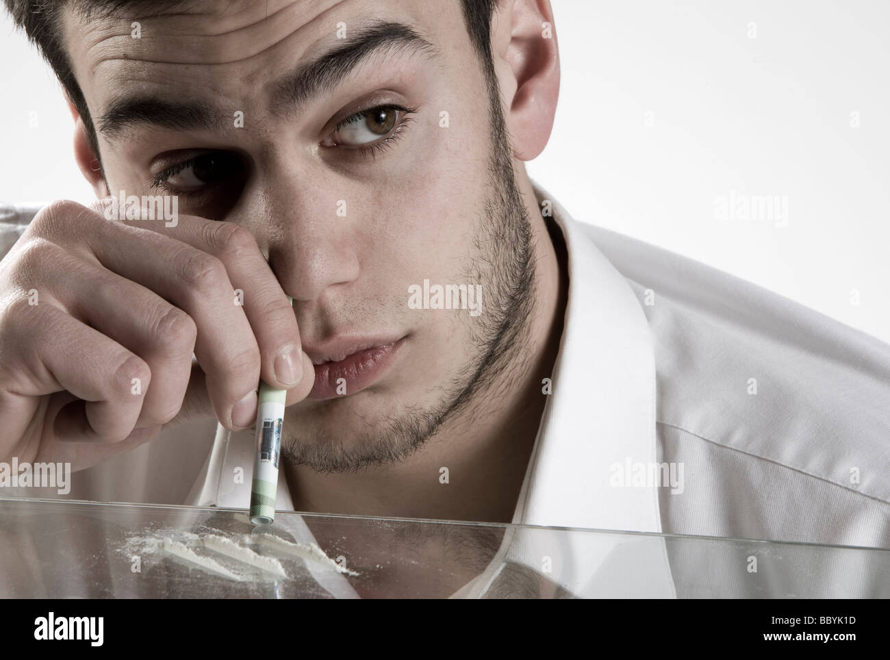 Young man sniffing cocaine Stoc